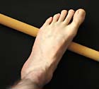 Rolling a stick under the foot sole